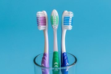 Toothbrushes on blue background. Flat lay composition with manual toothbrushes on color background, close up.