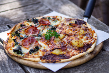 Fresh pizza on wood dish.