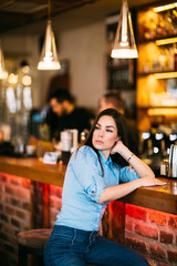 Pretty girl at cafe posing