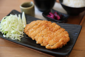 Tonkatsu fried pork cutlet with rice and soup on wooden table Japanese food