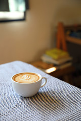 cappuccino or Latte art coffee made from milk on the wood table in coffee shop