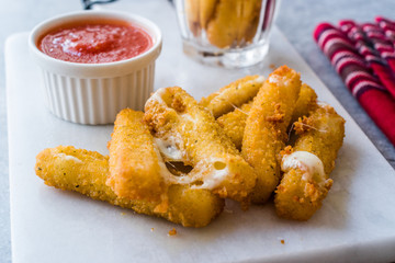 Breaded Fried Mozzarella Cheese Sticks with Ketchup Dipping Sauce.