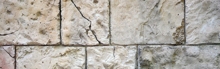 Fragment of ancient walls of fortification with large boulders close up