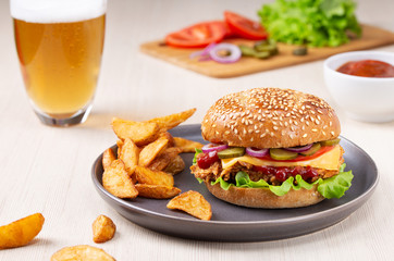 Burger on the plate with fried potatoes