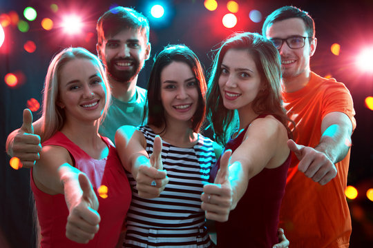 People showing OK sign in the night club