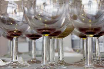 Wine glasses and bottles on the table after the exhibition opening and presentation.