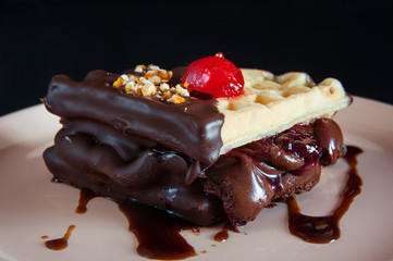 Belgian waffle with cherry and chocolate syrup.
