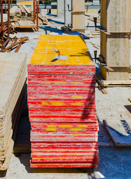 yellow wood panels, trowel and other materials stacked on site