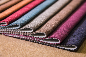 Colorful and bright fabric samples of furniture and clothing upholstery. Close-up of a palette of textile abstract stripes of different colors