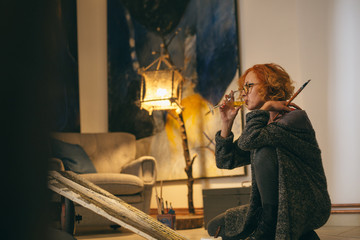 woman painting paint in her atelier