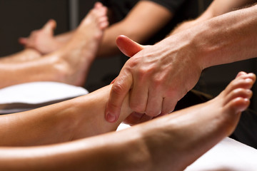 men's hands perform foot massage. close-up