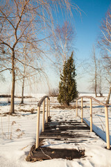 Frozen lake with ice and snow, sunny winter day. Forest.winter snowy landscape with forest, footpath,lake and blue sky. trees covered with snow. wintry frosty day.
