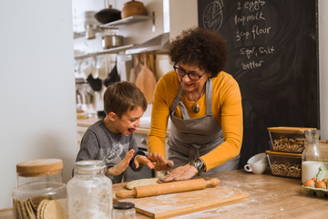 boy helping his grandmother in kitchen