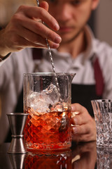 Barmen making negroni alcohol cocktail