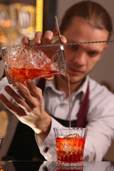 Barmen making negroni alcohol cocktail