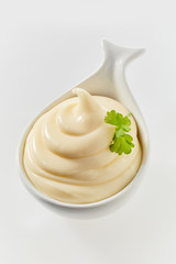 Twirled freshly made mayonnaise in a ceramic spoon