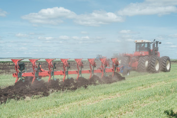 tractor plowing the land in the field