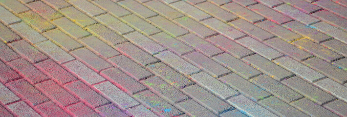 Multi colored paving slabs, powder coated with dry colors at the Holi festival