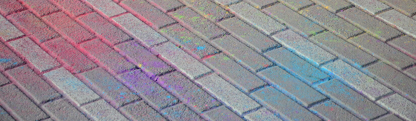 Multi colored paving slabs, powder coated with dry colors at the Holi festival