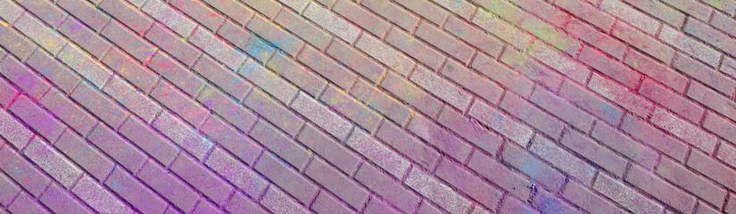 Multi colored paving slabs, powder coated with dry colors at the Holi festival