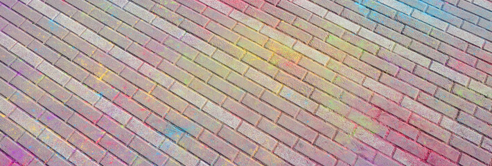 Multi colored paving slabs, powder coated with dry colors at the Holi festival