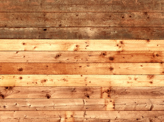 colorful old rustic wooden plank wall or floor with rich brown colored boards made of reused timber