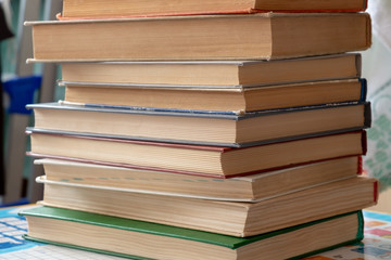 On the table is a stack of books with yellowed paper.