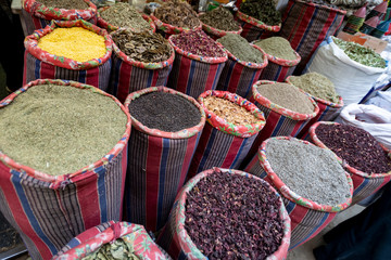  great variety of bright herbs and spices on the counter of the Arab market