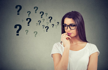 confused thinking woman seeking a solution looking preoccupied has many questions