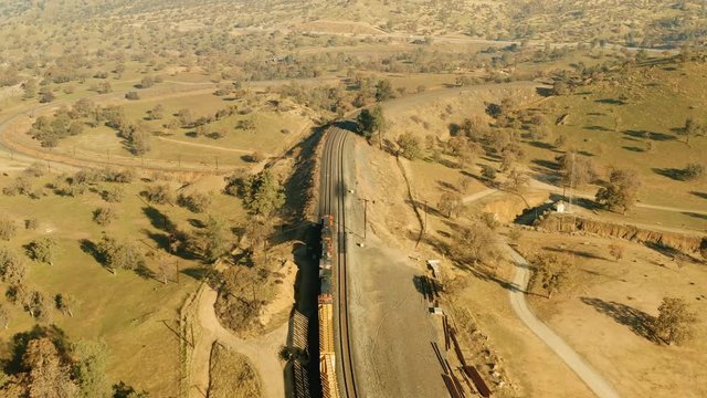 The aerial camera continues following the train passing over the loop tunnel then begins to circle around Cross Hill from 150 feet above the tracks.