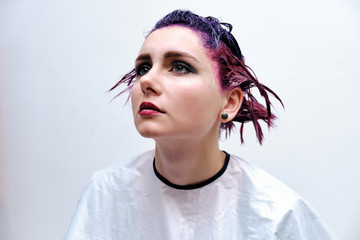 Beautiful girl with violet hair on white background master in make-up.