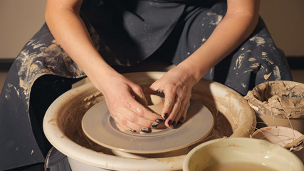 close up of woman's hands making a cool things from clay, slow motion