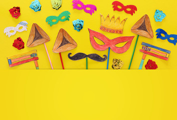 Purim celebration concept (jewish carnival holiday). Traditional symbols shapes cutted from paper and painted.