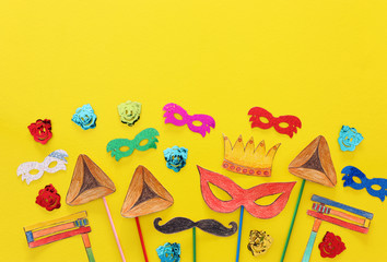Purim celebration concept (jewish carnival holiday). Traditional symbols shapes cutted from paper and painted.