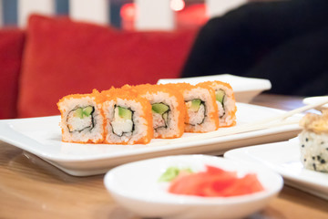 Rolls on a white plate in a restaurant. Food from fish. Japanese food. Restaurant beautiful dishes. Food