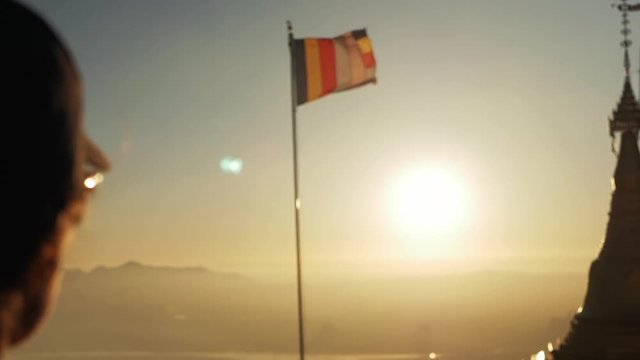Girl silhouette sunset mountain view buddha flag slow motion temple