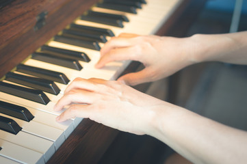 Musician hand playing piano keyboard.