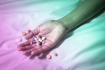 Medicine pills and capsules in woman hand.