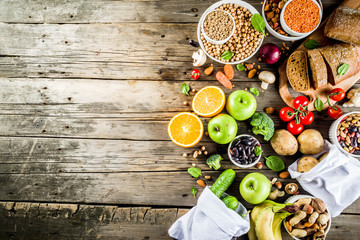 Fototapeta na wymiar Healthy food. Selection of good carbohydrate sources, high fiber rich food. Low glycemic index diet. Fresh vegetables, fruits, cereals, legumes, nuts, greens. copy space