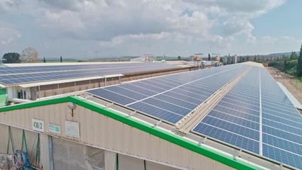 Aerial footage over chicken farm covered with solar panels in northern Israel