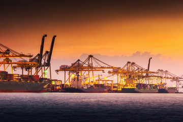 Fototapeta premium Transportation and shopping logistics loading dock terminal., Container import and export of sea freight transport industrial., Landscape of port maritime and harbor cargo shipyard with crane bridge.