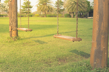 Wooden old swings in park