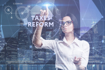 The concept of business, technology, the Internet and the network. A young entrepreneur working on a virtual screen of the future and sees the inscription: taxes reform