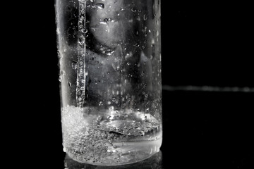 Splash of water on black, Stylish water splash. Isolated on black background, bubbles in the glass, the fog on the glass, water poured into the vessel