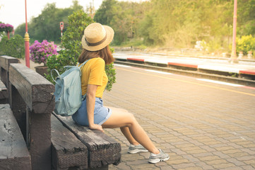 Woman waiting train at platform.