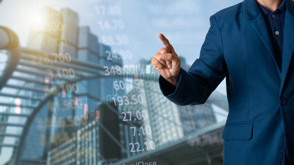 Businessman or ceo manager his fingers with finance and banking profit graph of stock market trade indicator financial