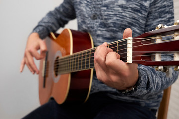 Close up of man playing acoustic guitar.