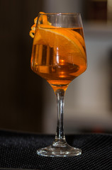 Refreshing cocktail with orange peel decoration