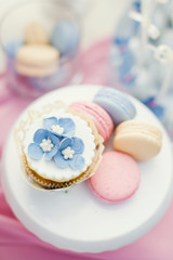 cupcakes with cream and flower decorations