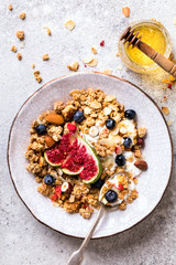 Muesli with Nuts Yogurt and fresh Figs Blueberry on the gray Background.Granola Healthy Breakfast. Sweet food Dessert. Snack  Dry Diet Nutrition Concept.Top View. Flat Lay.